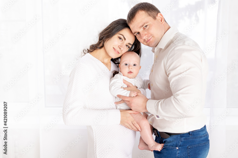 happy family mother and father hold a newborn baby at home, the concept of happy loving family, lifestyle happy family mother and father hold a newborn baby at home, the concept of happy loving family, lifestyle