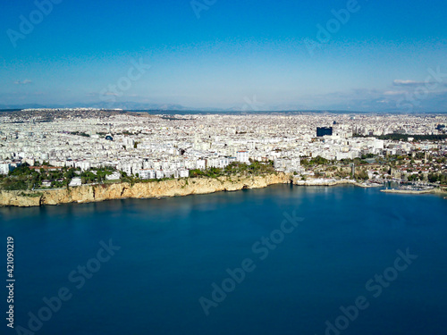 Aerial photograph of Antalya bay in Antalya city from high point of drone fly on sunny day in in Turkey. Amazing aerial cityscape view from birds fly altitude on beautiful town and sea full of yahts © Aleksey