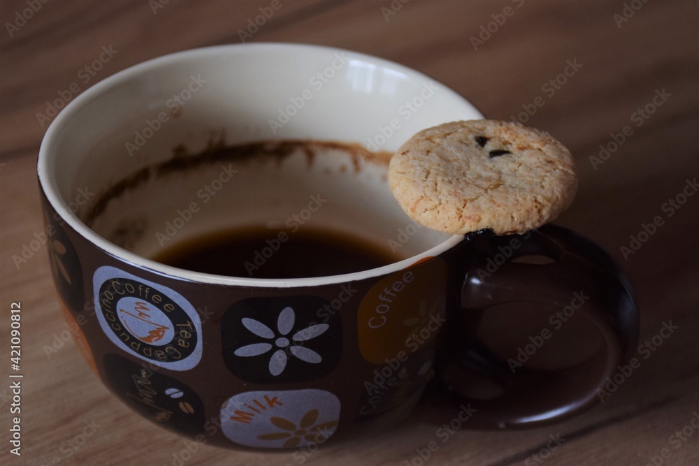 mug with a black coffee and cookie mug with a black coffee and cookie