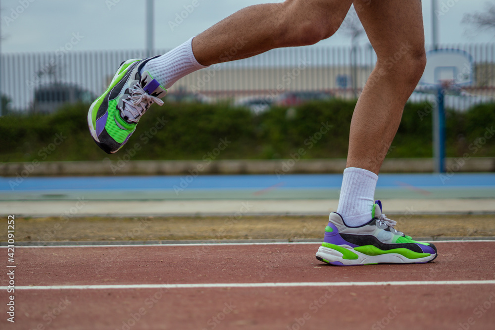 closeup of a runner running on the track closeup of a runner running on the track