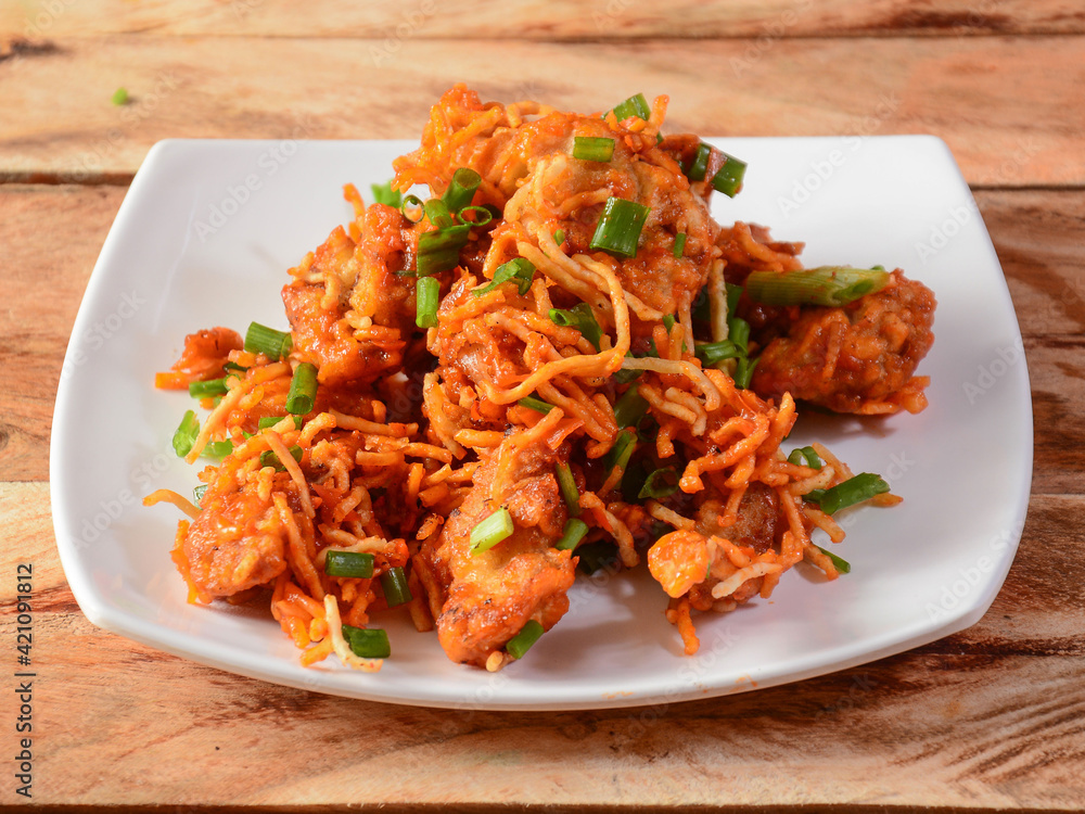 Chicken crispy fry - A spicy crispy fried appetizer in a wooden rustic background. selective focus Chicken crispy fry - A spicy crispy fried appetizer in a wooden rustic background. selective focus