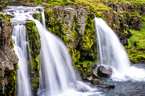 Grundarfjordur  Iceland Kirkjufell waterfall closeup smooth long exposure water on Snaefellsnes peninsula with green grass in summer