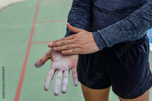 close up of hands with climbing chalk