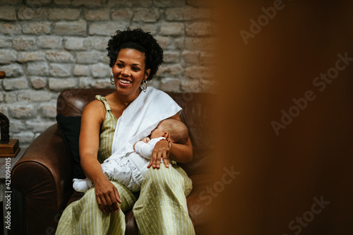 Photos Smiling woman breastfeeding her baby