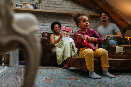 Multiracial family of three having fun at home