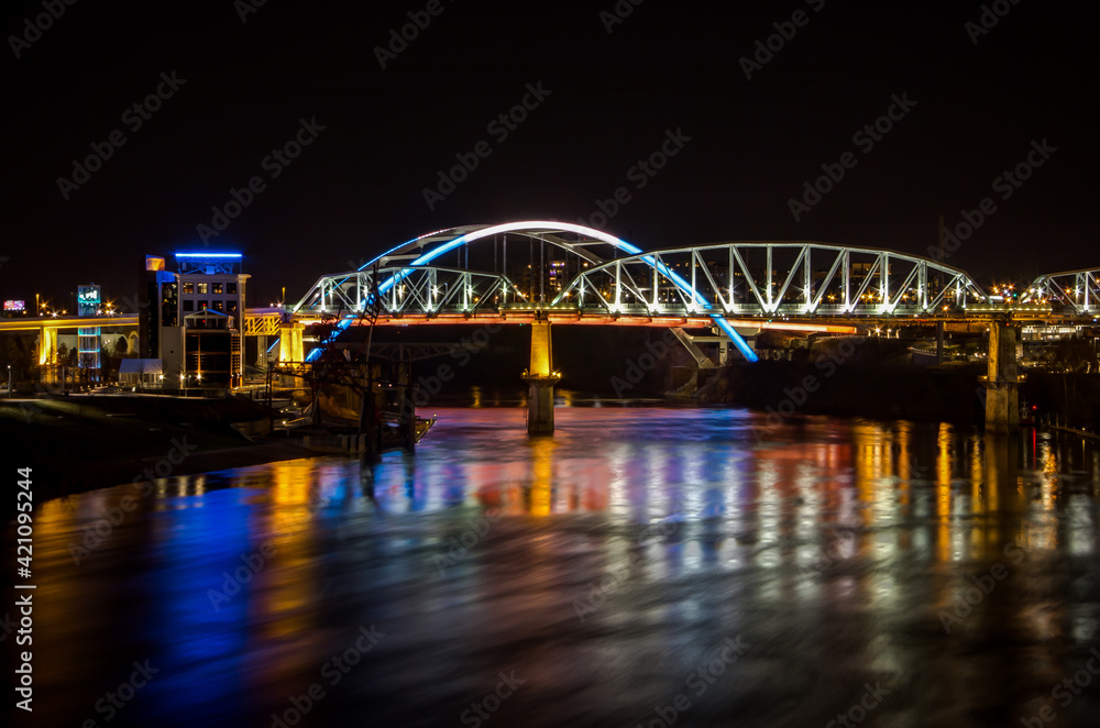 The John Seigenthaler Pedestrian Bridge at night as seen from Cumberland Park looking back at the Nashville downtown and the Korean Veterans Blvd Bridge 
