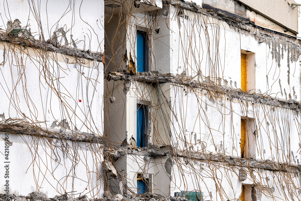 Rundown dilapidated broken building with wires cables hanging from white wall in Reykjavik, Iceland construction site of house home Rundown dilapidated broken building with wires cables hanging from white wall in Reykjavik, Iceland construction site of house home
