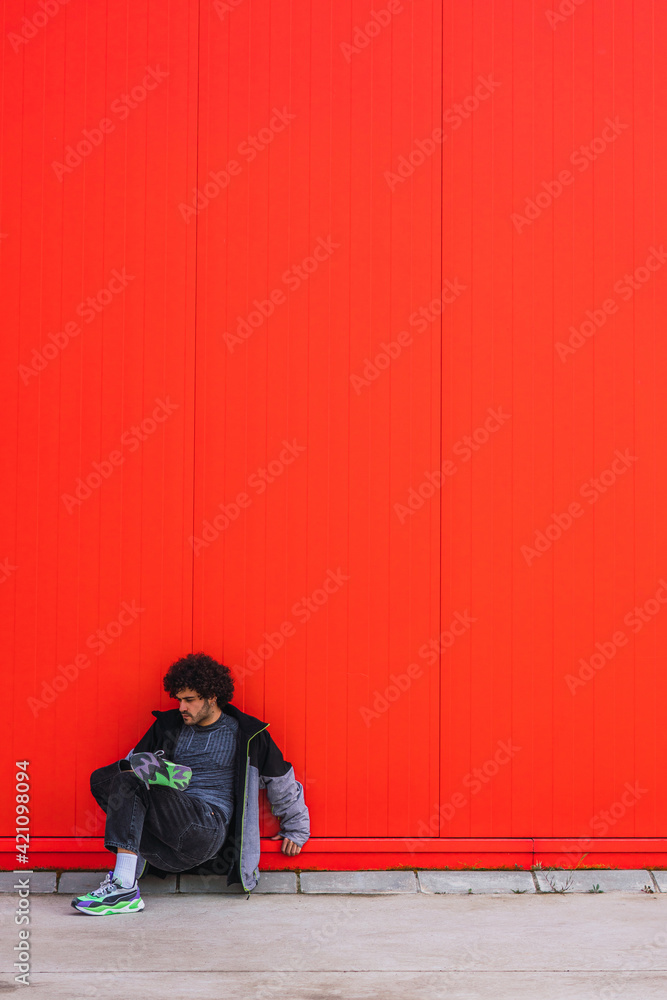Portrait of a young man dancing in a red wall Portrait of a young man dancing in a red wall