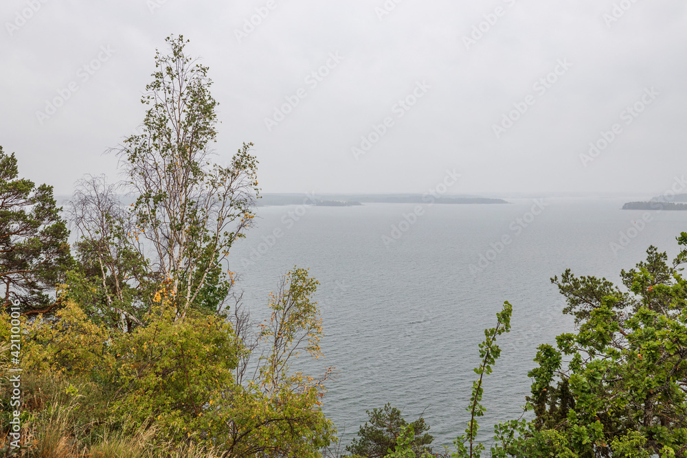 A wonderful view from mountains to nature with a view of Baltic Sea on a cloudy summer day. Sweden.