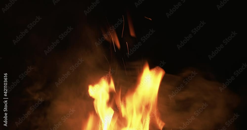Fire black. Flame texture. Glowing inferno. Wildfire danger. Bright yellow red burn sparks motion in smoke at night isolated on dark background. Fire black. Flame texture. Glowing inferno. Wildfire danger. Bright yellow red burn sparks motion in smoke at night isolated on dark background.