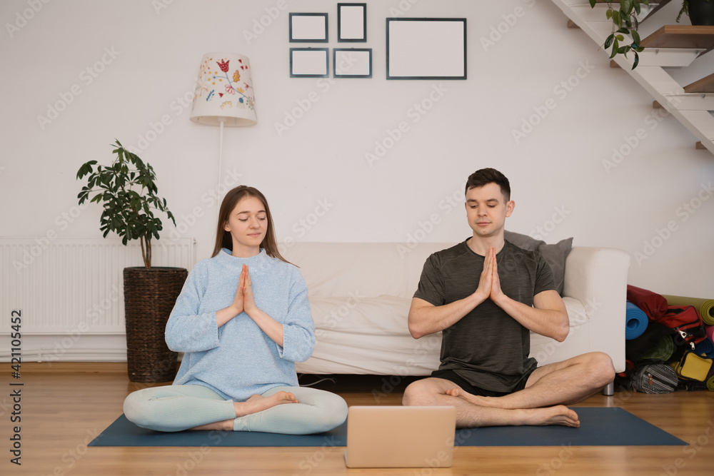 Beautiful couple practicing online yoga classes Beautiful couple practicing online yoga classes