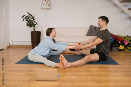 Beautiful couple practicing online yoga classes