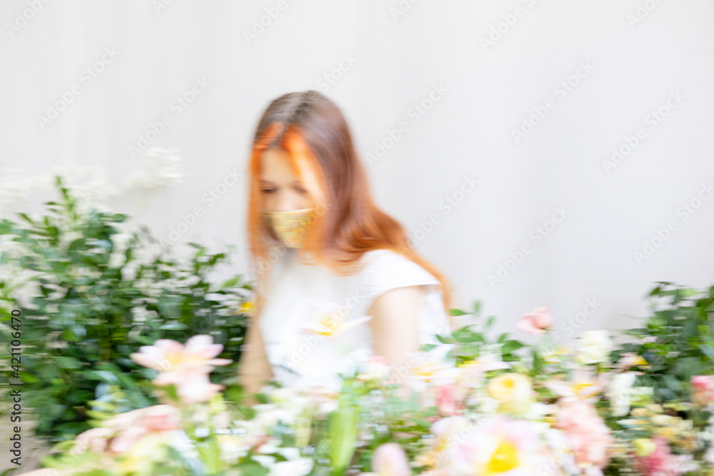 blurred in motion portrait of red haired teen girl among the flowers blurred in motion portrait of red haired teen girl among the flowers