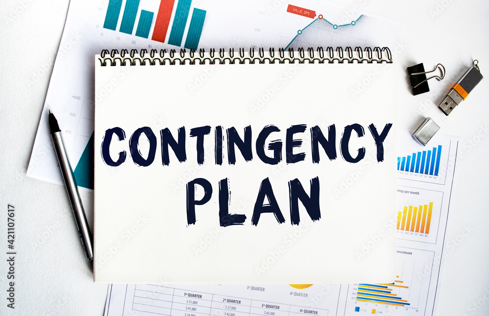 Notepad with the inscription CONTINGENCY PLAN. Conceptual image, business accessories, calculator isolated on the desktop. Finance or business concept. Notepad with the inscription CONTINGENCY PLAN. Conceptual image, business accessories, calculator isolated on the desktop. Finance or business concept.