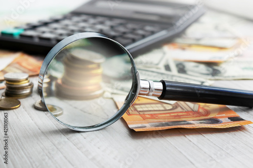 Calculator and magnifying glass. Office equipment at workplace. Conceptual image of desk work  financial paperwork and business economy.