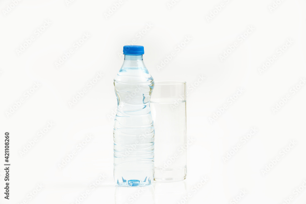 Water bottle and a glass of water against white background Water bottle and a glass of water against white background