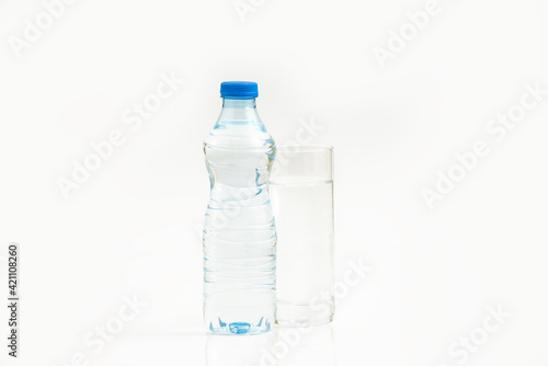 Water bottle and a glass of water against white background