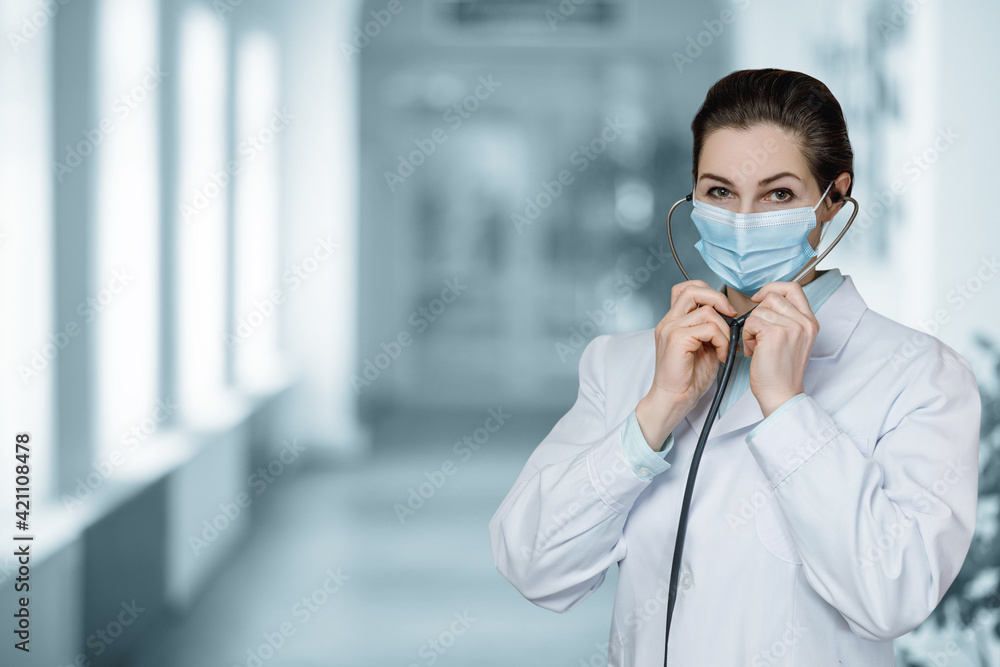Plakat Masked doctor holding stethoscope .