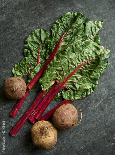 Sweet beet and leaves close up, chard, gray background