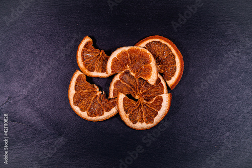 Dried orange slices on black background
