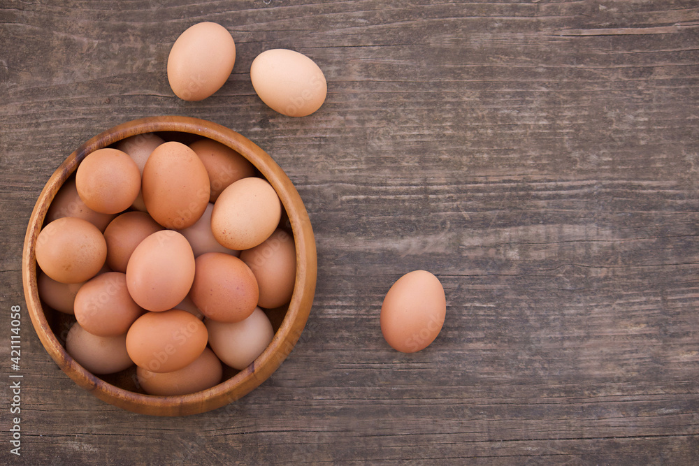 Bowl of fresh farm eggs on wooden background Bowl of fresh farm eggs on wooden background