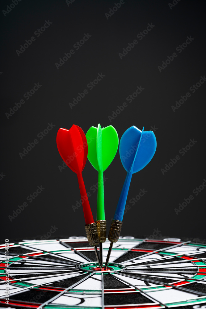 Dart hit target on black background Dart hit target on black background