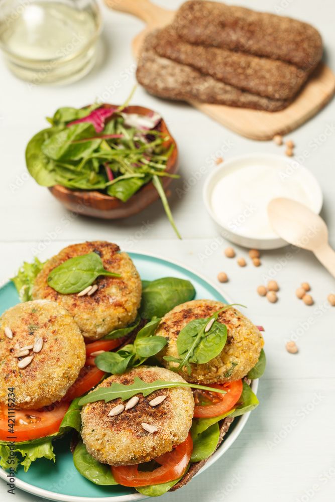 Rye bread sandwiches with falafel, tomatoes and green salad. Vertical frame, close-up, selective focus Rye bread sandwiches with falafel, tomatoes and green salad. Vertical frame, close-up, selective focus