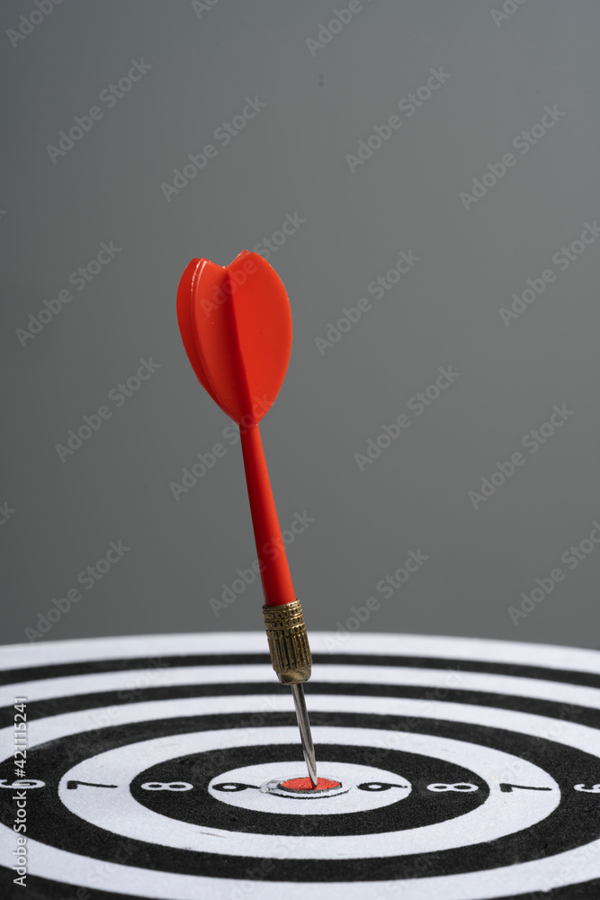 Dart hit target on black background Dart hit target on black background