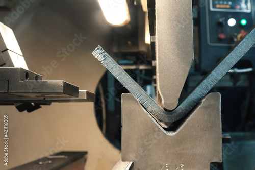 The process of metal bending on a CNC bending machine. Bending of metal using a v-shaped matrix and a punch. 