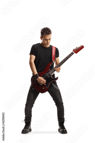 Full length portrait of a guy playing an electric guitar