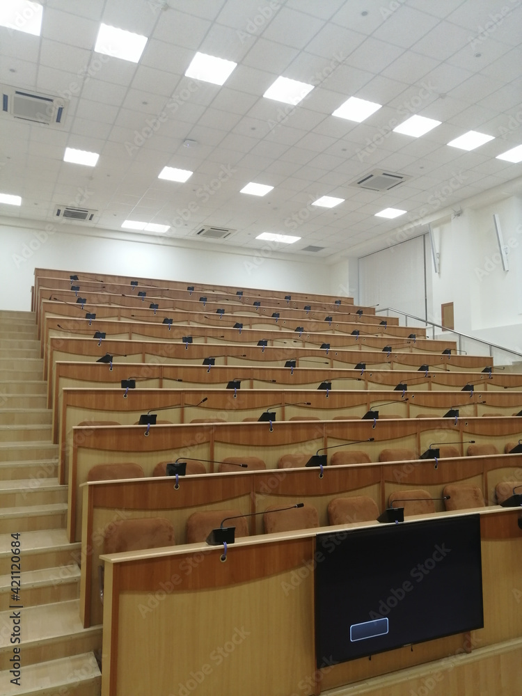 Fototapeta premium empty lecture room for students. lecture classroom, rows of empty wooden desks and seats