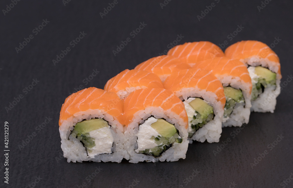 Sushi Rolls Philadelphia Maki wiwth Rice, SALMON, CREAM CHEESE, cucumber and avocado. Sushi Rolls Philadelphia Maki wiwth Rice, SALMON, CREAM CHEESE, cucumber and avocado.