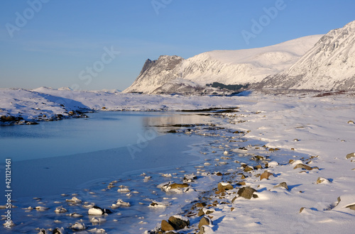 Seashore, mountains and snow, Lofoten Islands, North Norway