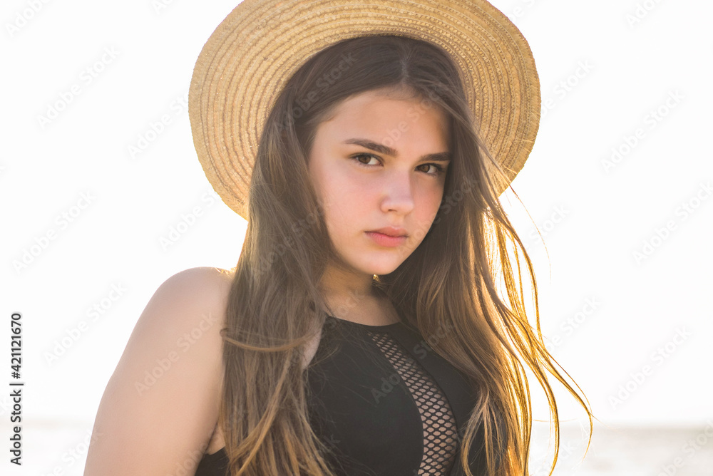 Cheerful plus size teenage girl wearing hat enjoying the beach. smiling, happy, positive emotion, summer style. Cheerful plus size teenage girl wearing hat enjoying the beach. smiling, happy, positive emotion, summer style.