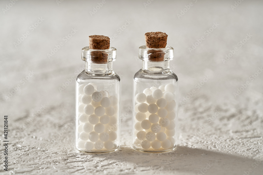 Two bottles of homeopathic pills on a white background Two bottles of homeopathic pills on a white background