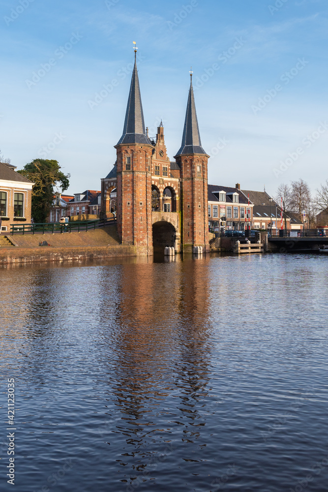 The towers of the famous Gate Waterpoort are reflected in the water