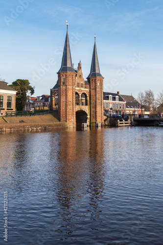 The towers of the famous Gate Waterpoort are reflected in the water