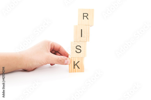 Hand hold wooden cubes with risk word. Risk management concept.