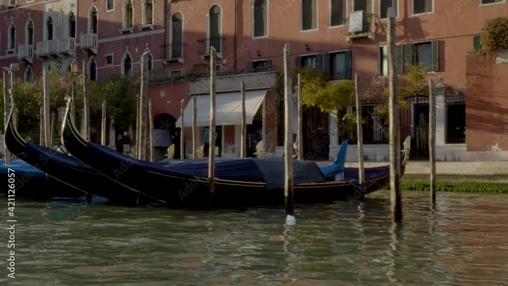 Moored gondolas with Venetian townhouses in background. Moored gondolas with Venetian townhouses in background.