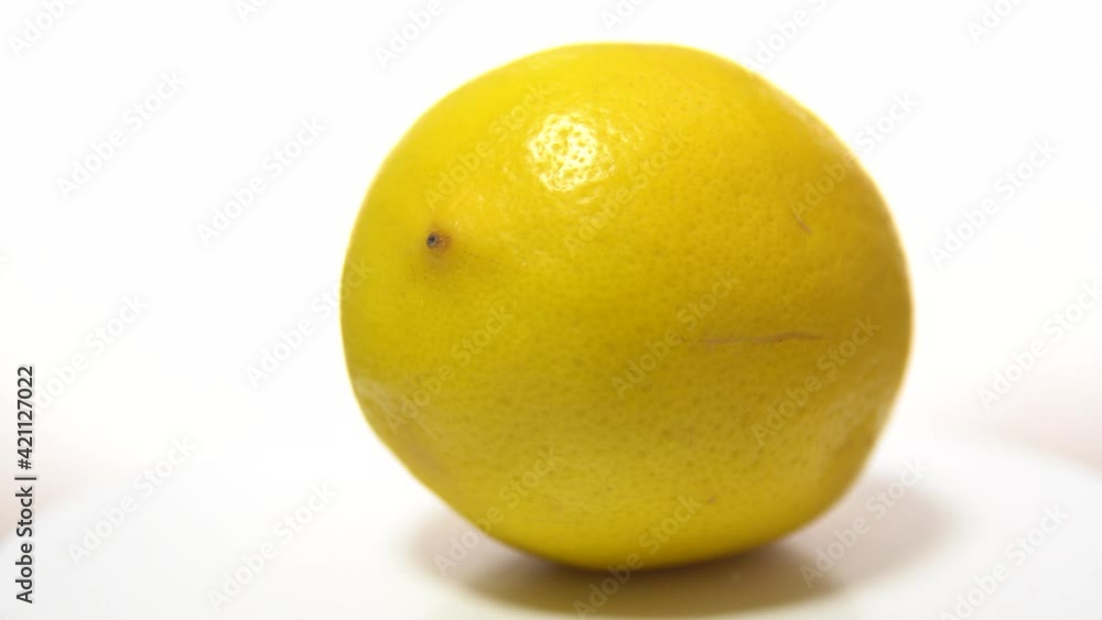 Yellow lemon on a white wooden table, rotation 360 degrees. White background. Yellow lemon on a white wooden table, rotation 360 degrees. White background.