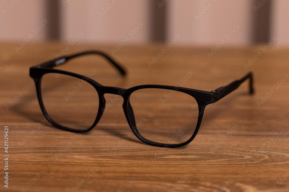 Pair of glasses on the wooden office table Pair of glasses on the wooden office table