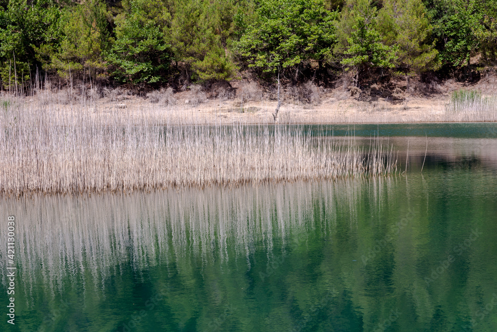 A view of the natural Lake Tsivilu (Peloponnesus, Greece) and mountains around on a sunny, summer day A view of the natural Lake Tsivilu (Peloponnesus, Greece) and mountains around on a sunny, summer day