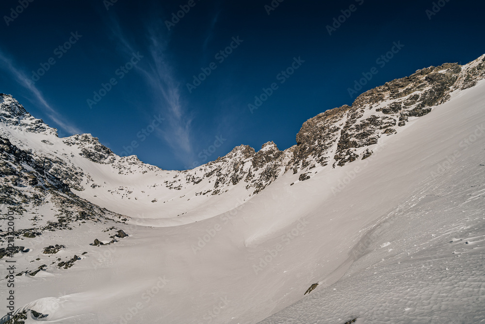 Beautiful winter mountain alpine like landscape of High Tatras, Slovakia. Snow in the mountains, rocky peaks of Gerlachovsky stit, Velicky stit and others. High Tatras National Park, Slovakia.