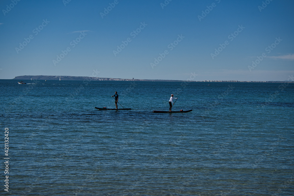 Fototapeta premium paddle surfing on the beach, located in Alicante, Spain.