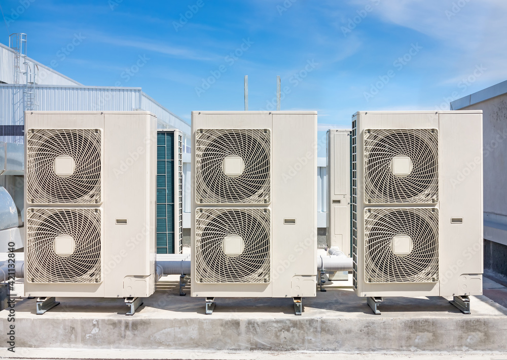 Condenser unit or compressor on roof of industrial plant building with