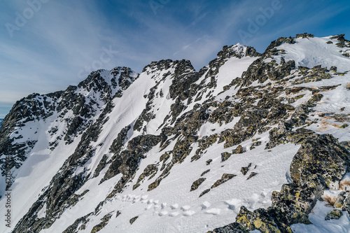 Beautiful winter mountain alpine like landscape of High Tatras, Slovakia. Snow in the mountains, rocky peaks of Gerlachovsky stit, Velicky stit and others. High Tatras National Park, Slovakia. photo