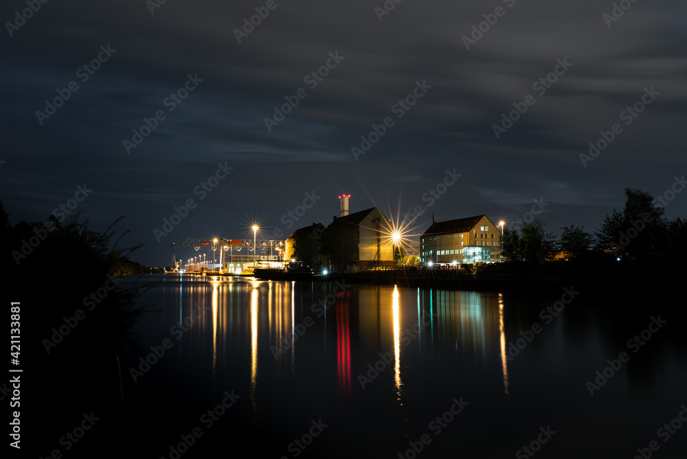 night view of the city with harbor and reflections on the water