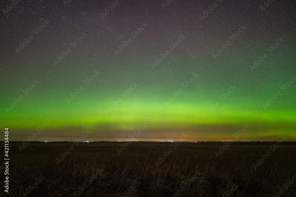 Stunning Aurora Borealis, Northern Lights display in rural farm field, inspirational beautiful landsape background and night sky wallpaper Stunning Aurora Borealis, Northern Lights display in rural farm field, inspirational beautiful landsape background and night sky wallpaper