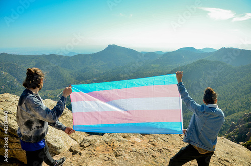 Two Men Showing Transgender Flag Blue and Pink on the Top of a Mountain (LGTB rights)