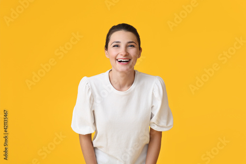 Happy young woman on color background © Pixel-Shot